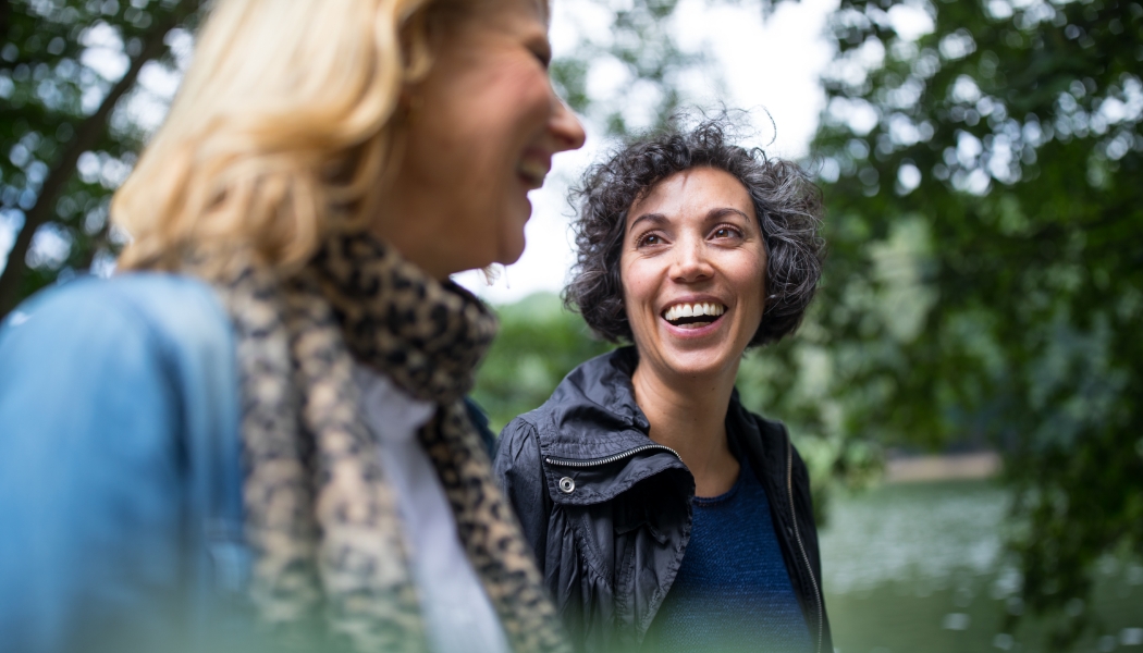 Friends laughing while on a walk