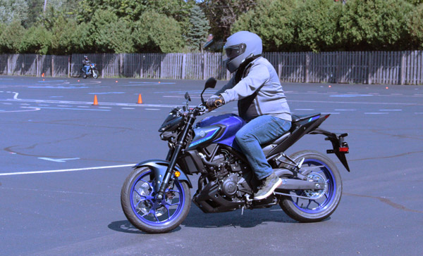 Motorcycle trainee maneuvering around the course