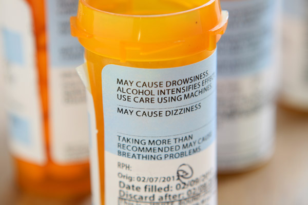 Prescription bottle showing "May cause drowsiness" on the label.