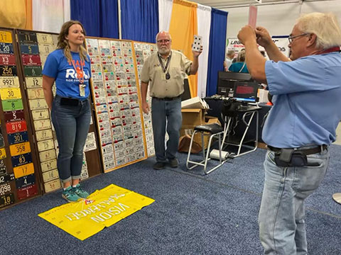 women standing while two men check her field of vision