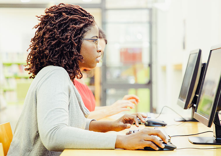 woman taking a test at a computer station