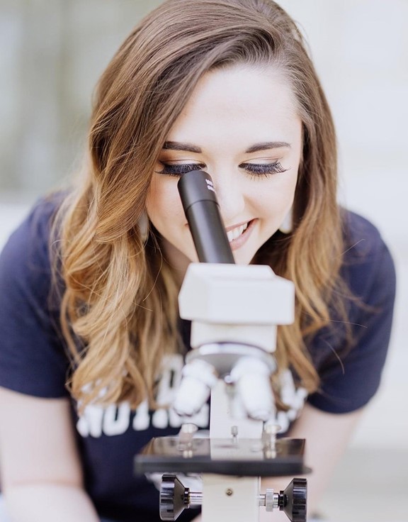 Haley Dahlhoff with microscope