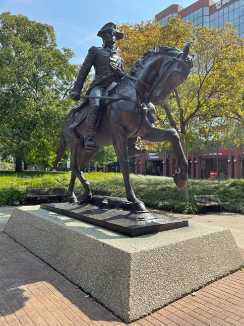 A statue of a person on a horseDescription automatically generated